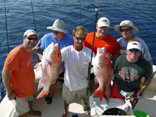 group holding up fish